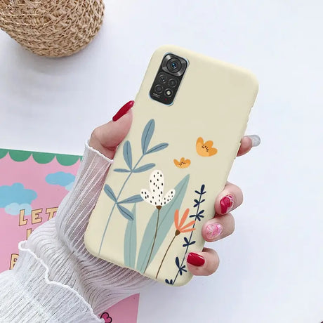 a woman holding a phone case with a flower design