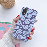 a woman holding a phone case with a pattern on it