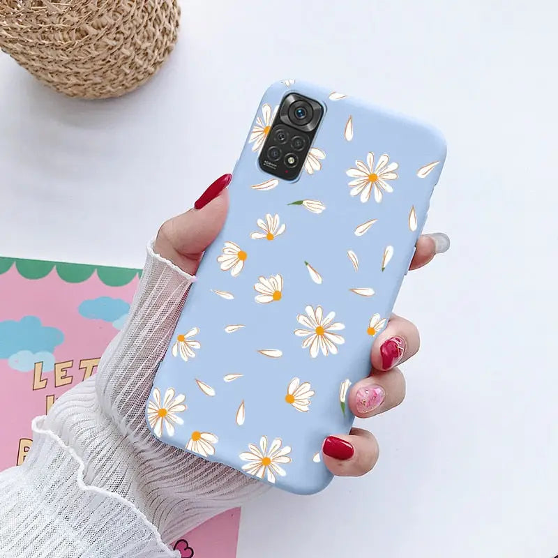 a woman holding a phone case with a flower pattern on it