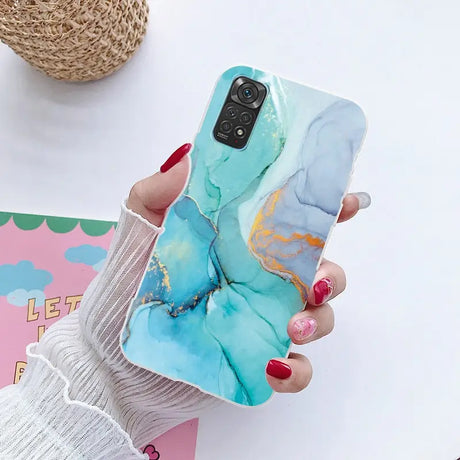 a woman holding a phone case with a marble marble pattern