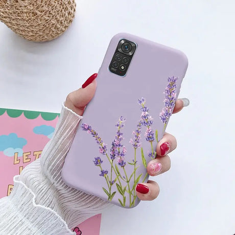 a woman holding a phone case with lavender flowers on it