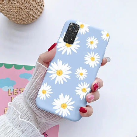 a close up of a person holding a phone with a flower pattern on it