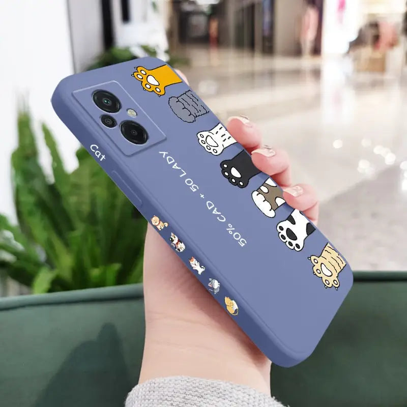 a woman holding a phone case with a cartoon cat and dog on it