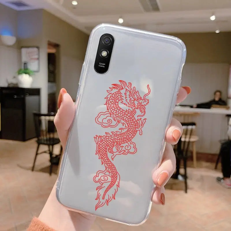 a woman holding a phone case with a red dragon on it