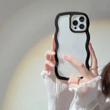a woman holding up a phone case