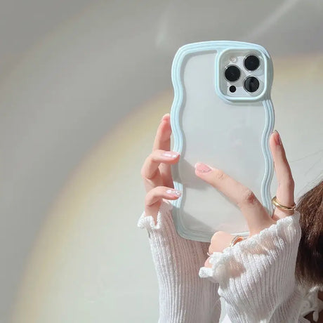 a woman holding up a phone case