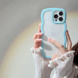 a woman holding up a phone case
