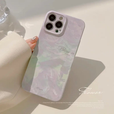 a woman holding a phone case with a marble pattern