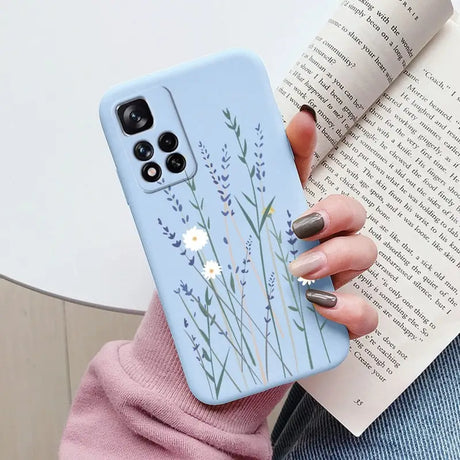 a woman holding a book and a phone case