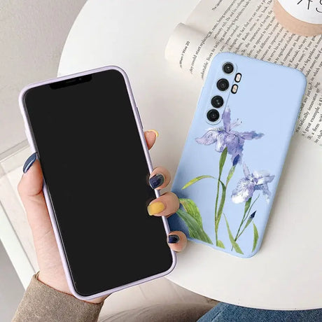 a woman holding a phone case with a flower on it