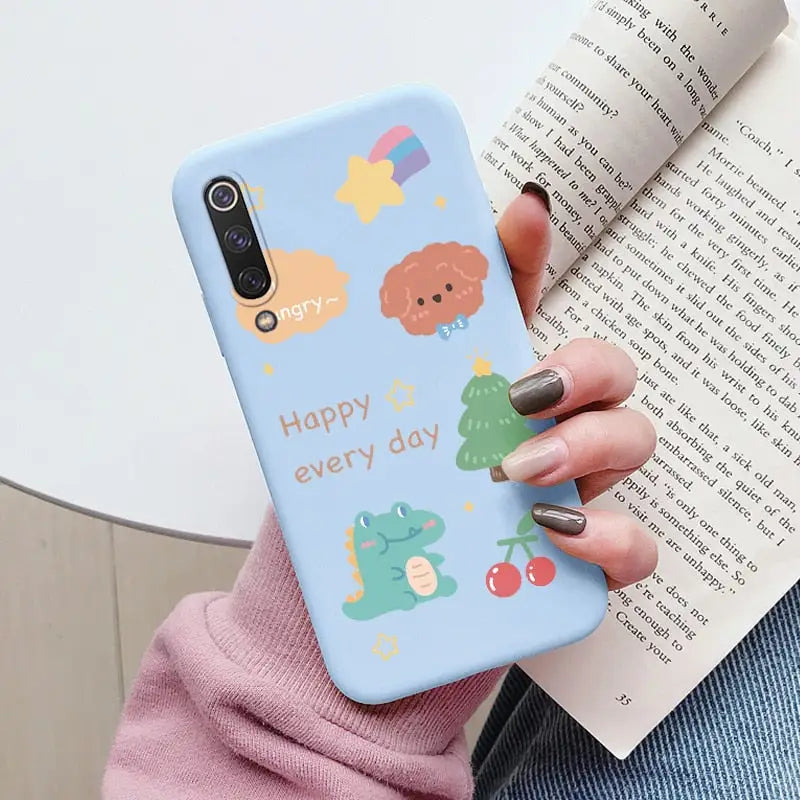 a woman holding a phone case with a cartoon design