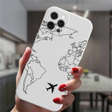a woman holding a phone case with a world map on it