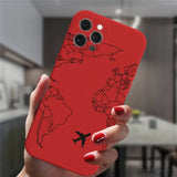 a woman holding a red phone case with a world map on it