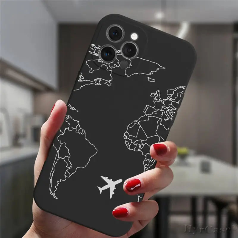 a woman holding a phone case with a world map on it