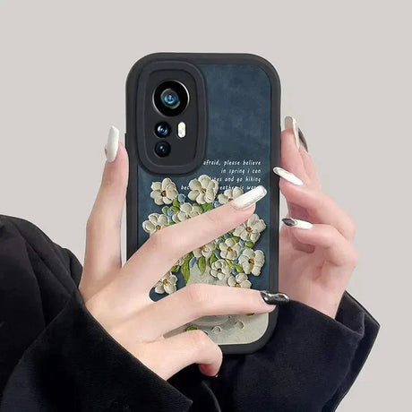 a woman holding a phone case with a flower design