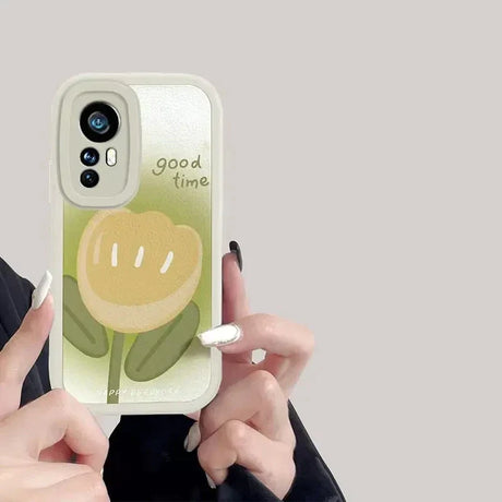 a woman holding a phone case with a flower on it