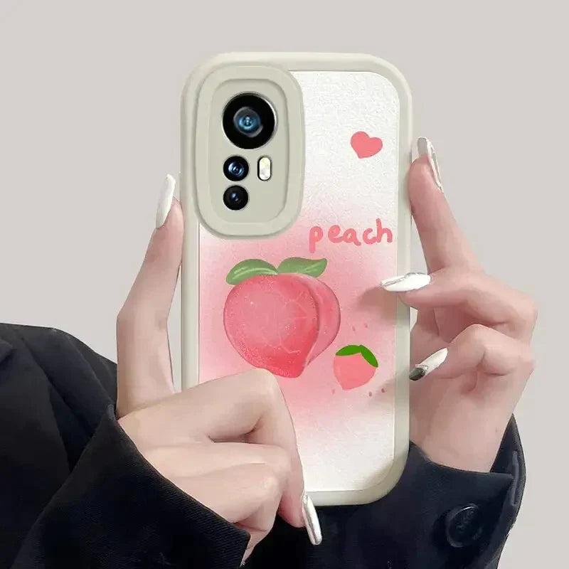 a woman holding a phone case with an apple on it
