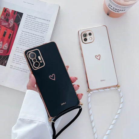 a woman holding a phone case with a heart on it