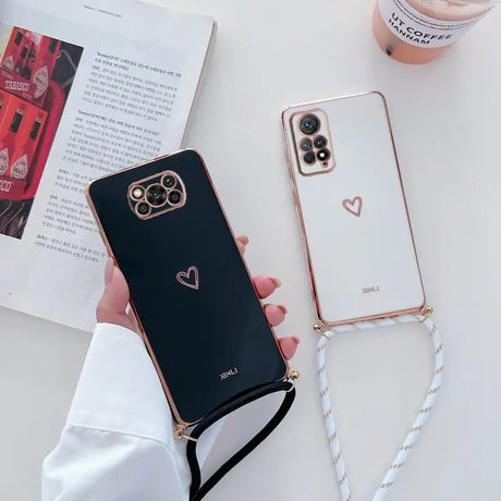 a woman holding a phone case with a heart on it