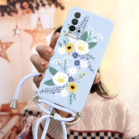 a woman holding a phone case with flowers on it