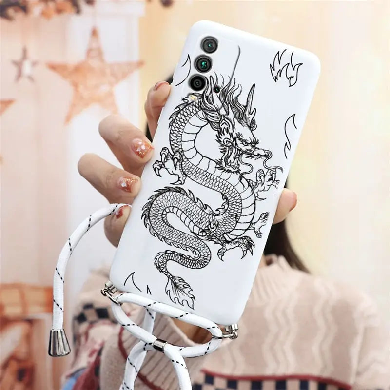 a woman holding a phone case with a dragon on it
