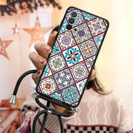 a woman holding a phone case with a colorful pattern