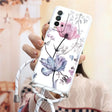 a woman holding a phone case with flowers on it