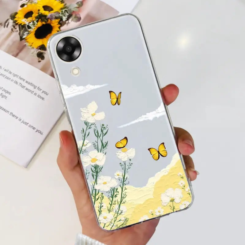 a woman holding a phone case with a yellow butterfly on it