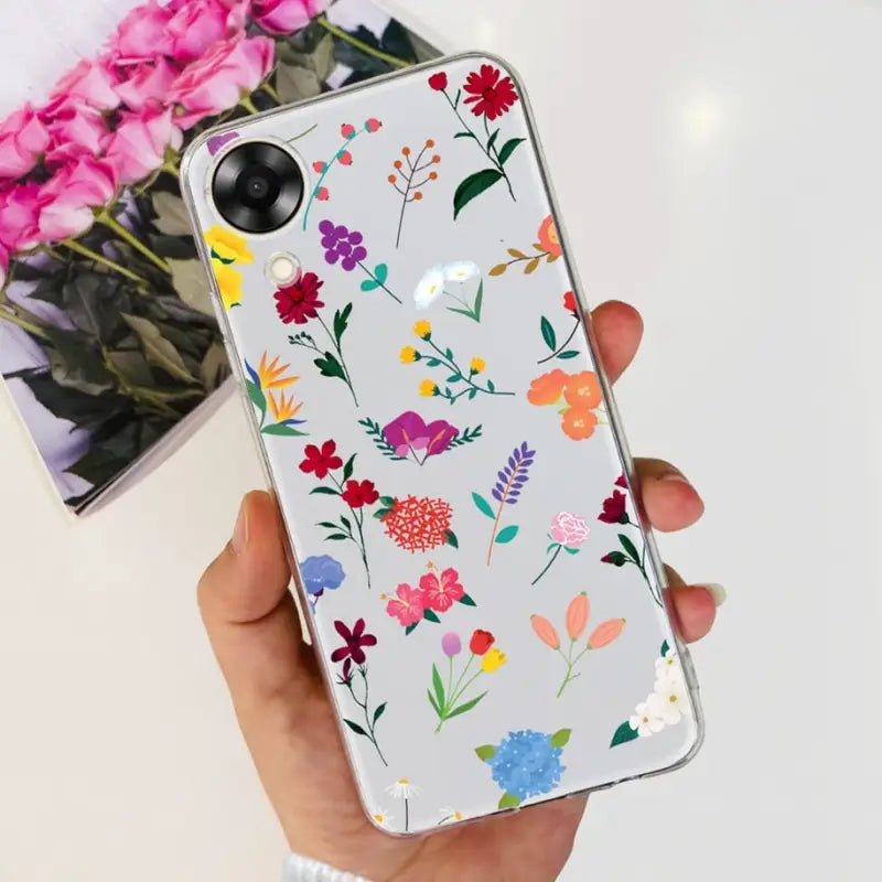 a woman holding a phone case with flowers on it