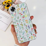 a woman holding a phone case with flowers on it