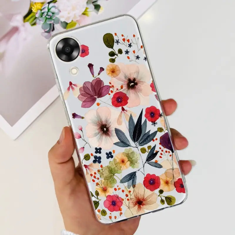 a woman holding a phone case with flowers on it