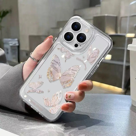 a woman holding a phone case with butterflies on it