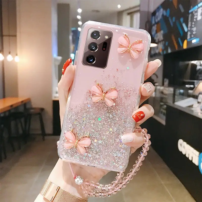 a woman holding a phone case with a bow