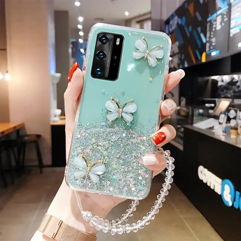 a woman holding a phone case with a butterfly on it