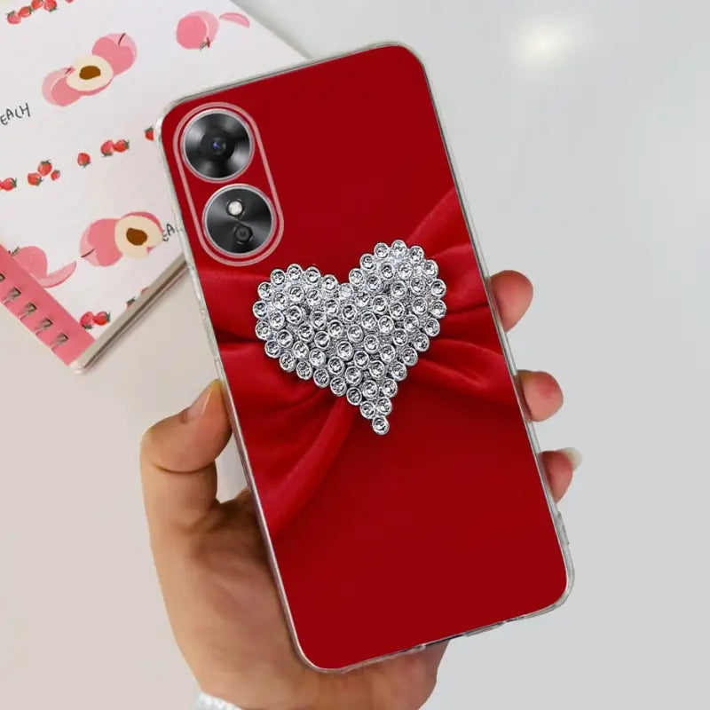 a woman holding a red phone case with a bow