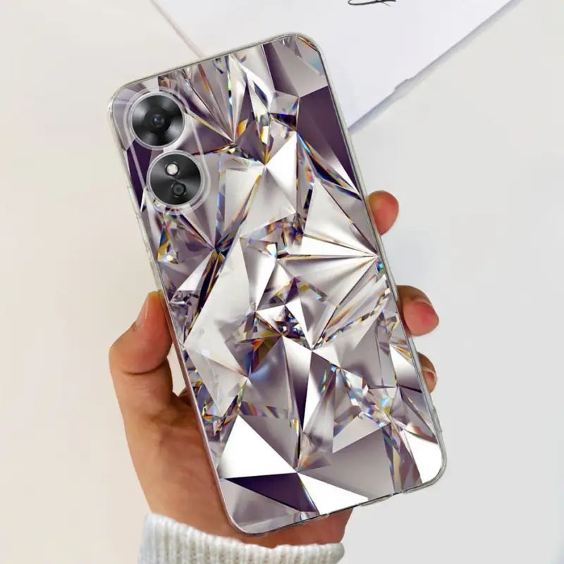 a woman holding a phone case with a diamond design