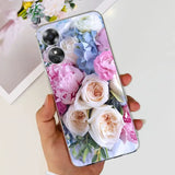 a woman holding a phone case with flowers on it