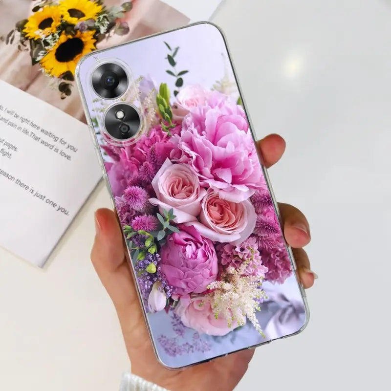 a woman holding a phone case with flowers