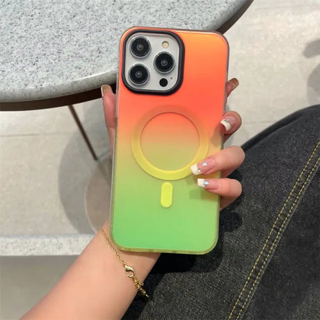 a woman holding a phone case with a rainbow colored gradient