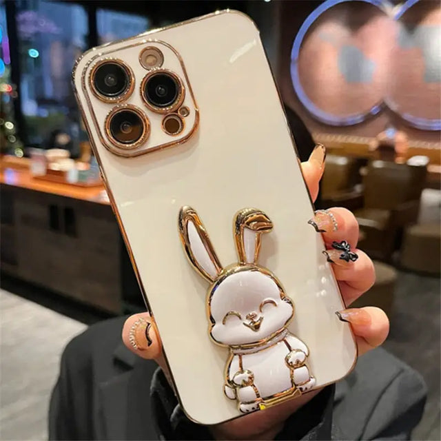 a person holding a phone case with a white rabbit