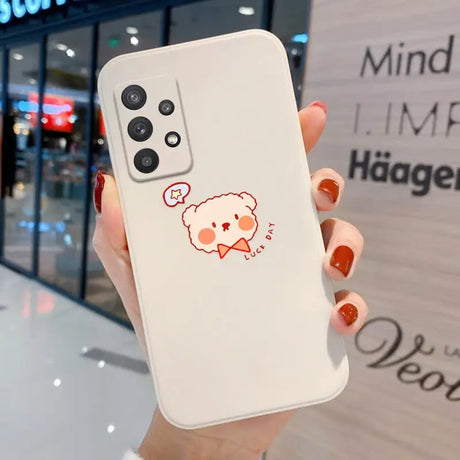 a woman holding a phone with a cartoon bear on it