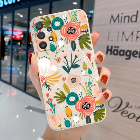 a woman holding a phone case with a floral pattern