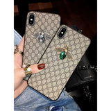 a woman holding a phone case with a ring on it