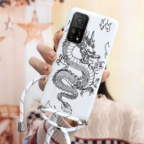 a woman holding a phone case with a dragon on it