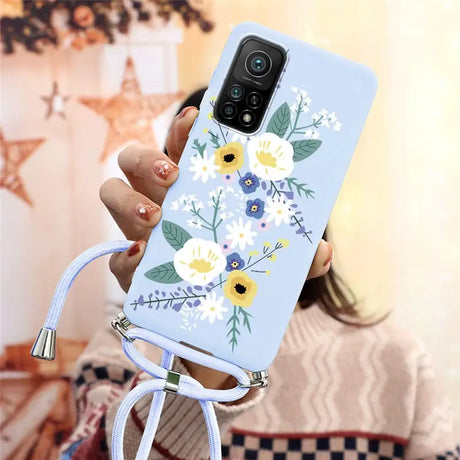 a woman holding a phone case with flowers on it