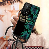 a woman holding a phone case with a tropical leaf design