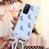 a woman holding a phone case with a pattern of dinosaurs