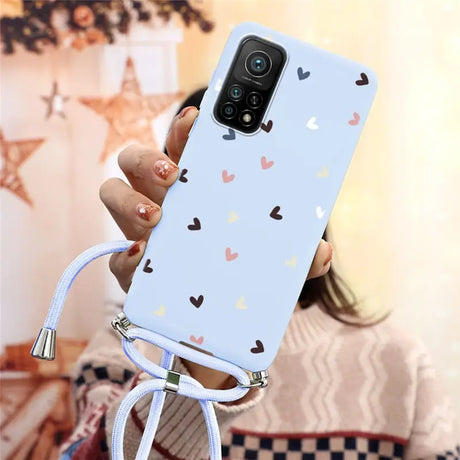 a woman holding a phone case with hearts on it