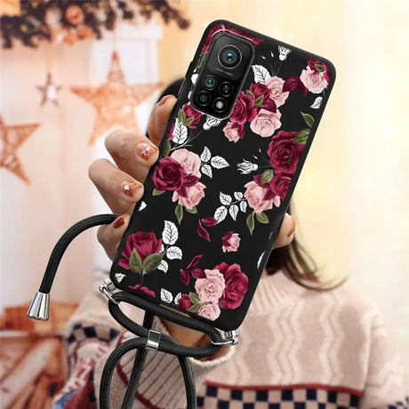 a woman holding a phone case with flowers on it