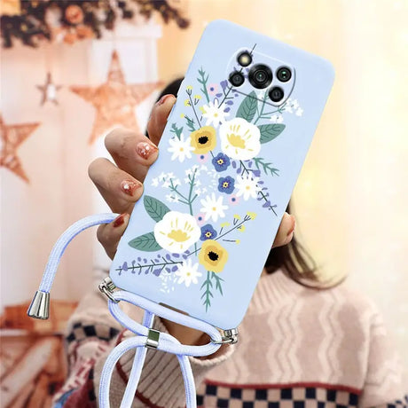 a woman holding a phone case with flowers on it